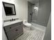 Modern bathroom with gray tile, frameless shower, and gray vanity at 1134 Donnelly Sw Ave, Atlanta, GA 30310