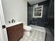 Modern bathroom with patterned floor tile, frameless shower, and floating vanity at 1134 Donnelly Sw Ave, Atlanta, GA 30310