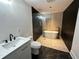 Modern bathroom with walk-in shower, soaking tub, and marble floors at 1134 Donnelly Sw Ave, Atlanta, GA 30310