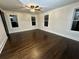 Bright bedroom featuring hardwood floors, ceiling fan, and multiple windows at 1134 Donnelly Sw Ave, Atlanta, GA 30310