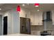 Updated kitchen with white cabinets, quartz countertops and red pendant lights at 1134 Donnelly Sw Ave, Atlanta, GA 30310