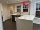 L-shaped kitchen with white cabinets, quartz countertops, and farmhouse sink at 1134 Donnelly Sw Ave, Atlanta, GA 30310