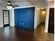 Living room with dark hardwood floors and blue accent wall at 1134 Donnelly Sw Ave, Atlanta, GA 30310