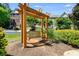 Wooden swing and pergola in a landscaped community area at 2853 Brandl Cove Ct # 1, Marietta, GA 30067