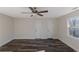 Bedroom featuring hardwood floors, neutral walls, ceiling fan, and two entry doors at 880 Streamside Dr, Mcdonough, GA 30252