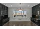 Elegant dining room featuring dark cabinets, hardwood floors, and natural light from the large window at 880 Streamside Dr, Mcdonough, GA 30252