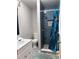 Bathroom features blue tiled shower with patterned floor at 6185 Bermuda St, Forest Park, GA 30297
