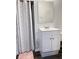 Bathroom with white vanity, sink, and patterned shower curtain at 6185 Bermuda St, Forest Park, GA 30297