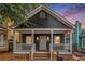 Charming dark gray one-story home with a welcoming front porch, white trim, and brick-lined steps at 400 Bass Sw St, Atlanta, GA 30310