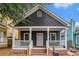 Charming dark gray one-story home with a welcoming front porch, white trim, and brick-lined steps at 400 Bass Sw St, Atlanta, GA 30310