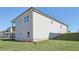 Rear exterior view showcasing a well-maintained yard, gray siding, and multiple windows at 24 Dew Lake Ct, Grayson, GA 30017