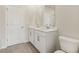 Bathroom featuring double sinks, white cabinetry, and hardwood floors at 24 Dew Lake Ct, Grayson, GA 30017