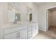 This bright bathroom features a double vanity with bright white cabinets at 24 Dew Lake Ct, Grayson, GA 30017