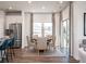 Elegant dining room with a round table, neutral chairs, and a sliding door to the outdoor area at 24 Dew Lake Ct, Grayson, GA 30017