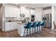 Modern kitchen with stainless steel appliances, white cabinetry, a center island, and bar stool seating at 24 Dew Lake Ct, Grayson, GA 30017