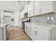 Bright kitchen features white cabinets, stainless steel appliances, and a stylish backsplash at 24 Dew Lake Ct, Grayson, GA 30017