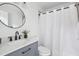 Modern bathroom with gray vanity, white quartz countertop, and white shower curtain at 2746 King Arthur Ct, Buford, GA 30519