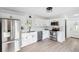 Modern kitchen with white shaker cabinets, stainless steel appliances, and quartz countertops at 2746 King Arthur Ct, Buford, GA 30519