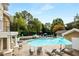 Community pool with lounge chairs and umbrellas at 2700 Pine Tree Ne Rd # 2212, Atlanta, GA 30324