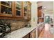 Butlers pantry features wine storage and granite top at 320 Town Center Ave # U206B, Suwanee, GA 30024