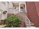 Townhouse entrance with brick stairs and landscaping at 320 Town Center Ave # U206B, Suwanee, GA 30024