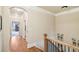 Upstairs hallway with hardwood floors and access to bedrooms at 320 Town Center Ave # U206B, Suwanee, GA 30024