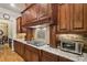 Kitchen features granite countertops, dark wood cabinets, and gas cooktop at 320 Town Center Ave # U206B, Suwanee, GA 30024