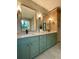 Bathroom with double sink vanity, green cabinets and modern fixtures at 322 Reed St, Scottdale, GA 30079