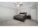 Main bedroom with carpeted floor, ceiling fan, and dark comforter at 24 Thunderhawk Ne Ln, Rydal, GA 30171