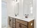 Modern bathroom with double vanity and dark brown cabinets at 1475 Auburn Glen Rd, Dacula, GA 30019