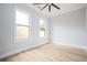 Light-filled bedroom with hardwood floors and a ceiling fan at 600 Jones Rd, Roswell, GA 30075