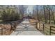 Long driveway leading to a modern home with a gated entrance at 600 Jones Rd, Roswell, GA 30075