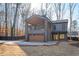 Modern farmhouse exterior with metal roof and stone accents at 600 Jones Rd, Roswell, GA 30075