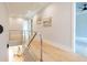 Light and bright hallway with hardwood floors and modern cable railing at 600 Jones Rd, Roswell, GA 30075