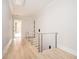 Bright hallway with hardwood floors and modern staircase at 600 Jones Rd, Roswell, GA 30075