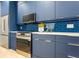 Modern kitchen with navy blue cabinets and stainless steel appliances at 600 Jones Rd, Roswell, GA 30075