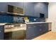 Modern kitchen with stainless steel appliances and blue cabinetry at 600 Jones Rd, Roswell, GA 30075