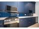 Modern kitchen with navy blue cabinets and white quartz countertops at 600 Jones Rd, Roswell, GA 30075