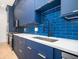 Modern kitchen with navy blue cabinets and white quartz countertops at 600 Jones Rd, Roswell, GA 30075