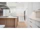 Modern kitchen with white cabinets, quartz countertops and hardwood floors at 600 Jones Rd, Roswell, GA 30075