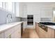 Modern kitchen with white cabinets and light wood flooring at 600 Jones Rd, Roswell, GA 30075