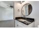 Modern bathroom with dark vanity and a round mirror at 884 Derrydown Way, Decatur, GA 30030