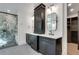 Double vanity bathroom with dark cabinetry, quartz countertops, and a large shower at 884 Derrydown Way, Decatur, GA 30030