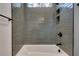 Grey tiled shower and bathtub with window at 884 Derrydown Way, Decatur, GA 30030