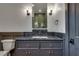 Bathroom vanity with dark countertop and double sinks at 884 Derrydown Way, Decatur, GA 30030