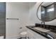 Modern bathroom with dark tile, floating vanity, and round mirror at 884 Derrydown Way, Decatur, GA 30030