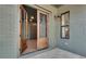 Front entry with rustic wood double doors and brick facade at 884 Derrydown Way, Decatur, GA 30030