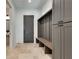 Mudroom with built-in bench, storage cabinets and tile flooring at 884 Derrydown Way, Decatur, GA 30030