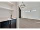 Modern wet bar with dark cabinetry, quartz countertops, and beverage fridge at 884 Derrydown Way, Decatur, GA 30030