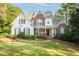 Charming two-story home features a welcoming front porch, brick accents, and lush landscaping at 6234 Creekstone Path, Cumming, GA 30041